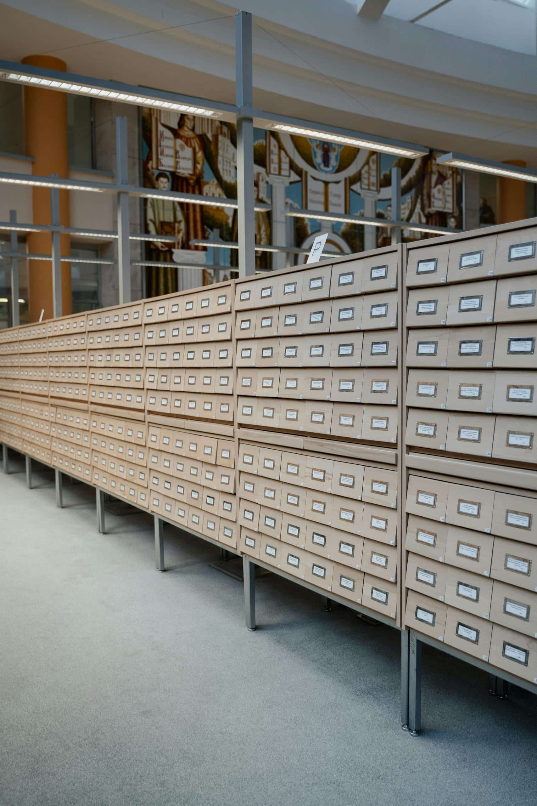 A modern library interior featuring a neat and expansive card catalog system.